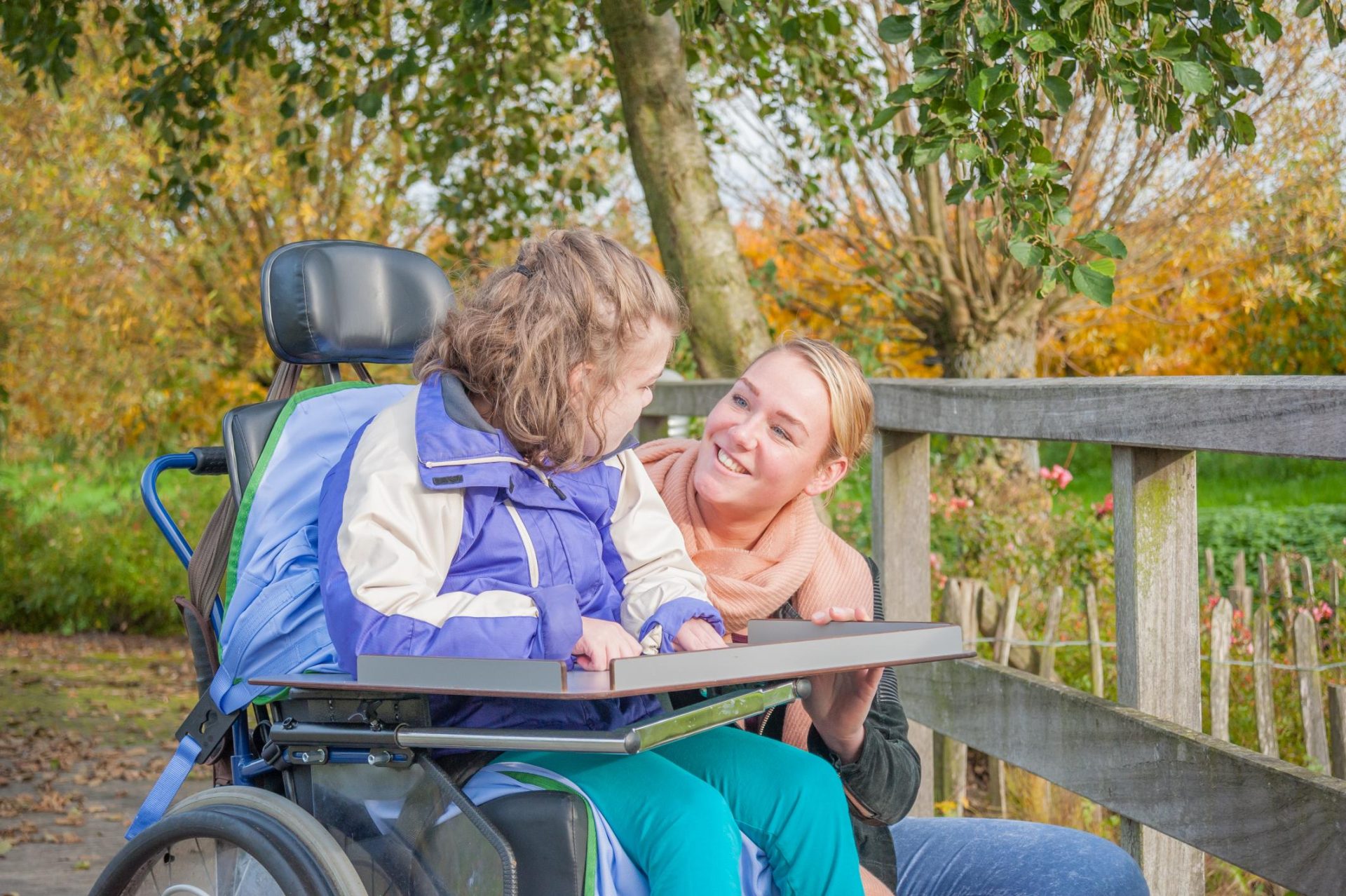 Carer helping young girl with tailored assistance needs