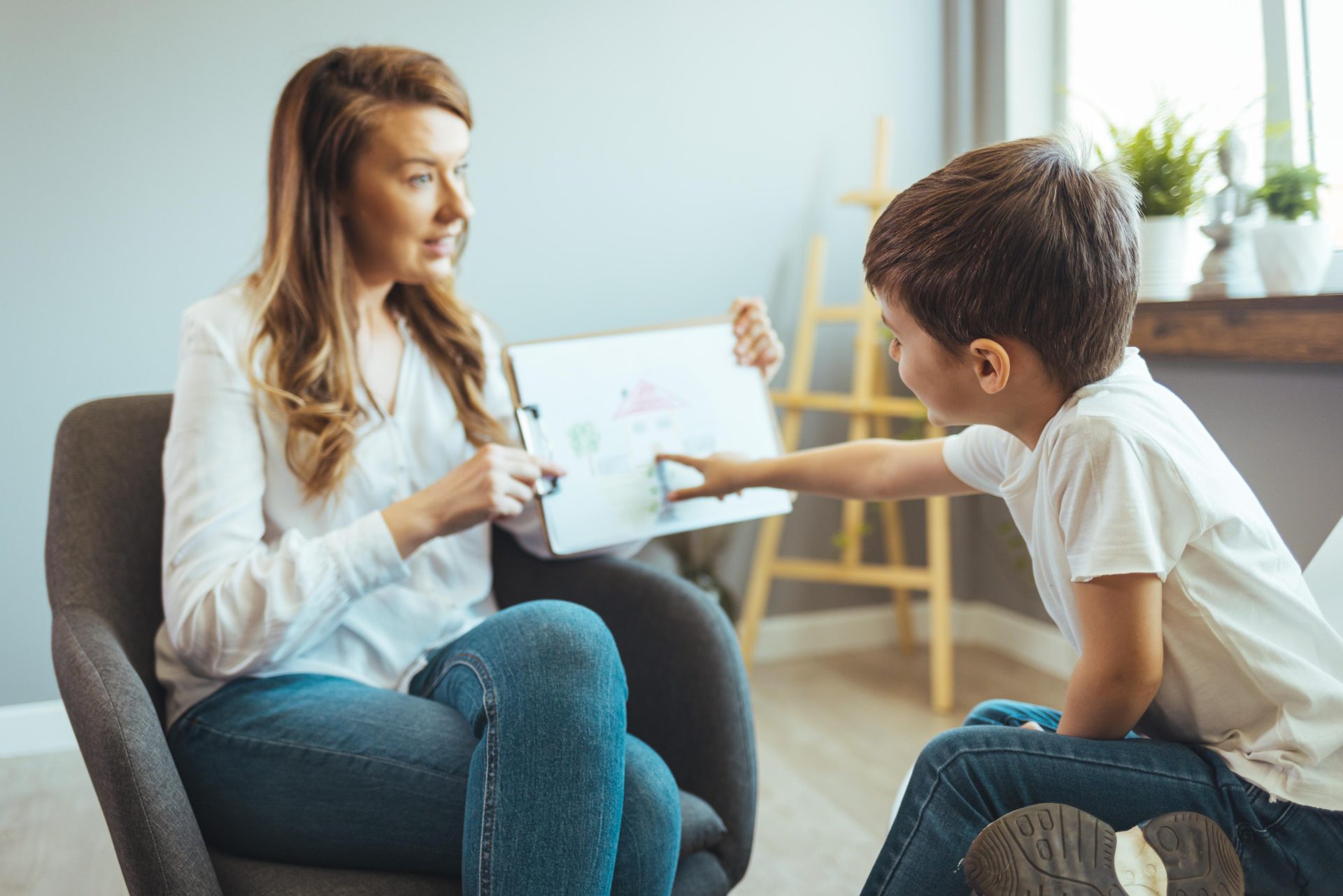 Carer helping little boy learn