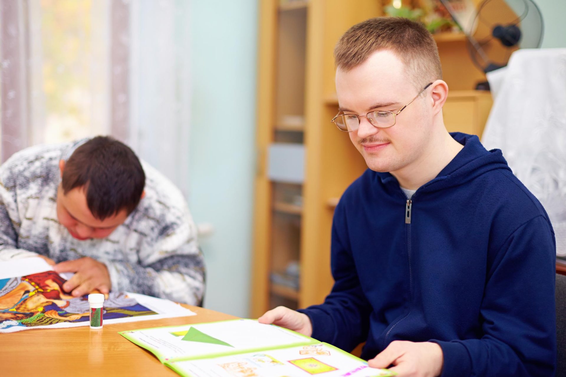 Boy studying with colleague